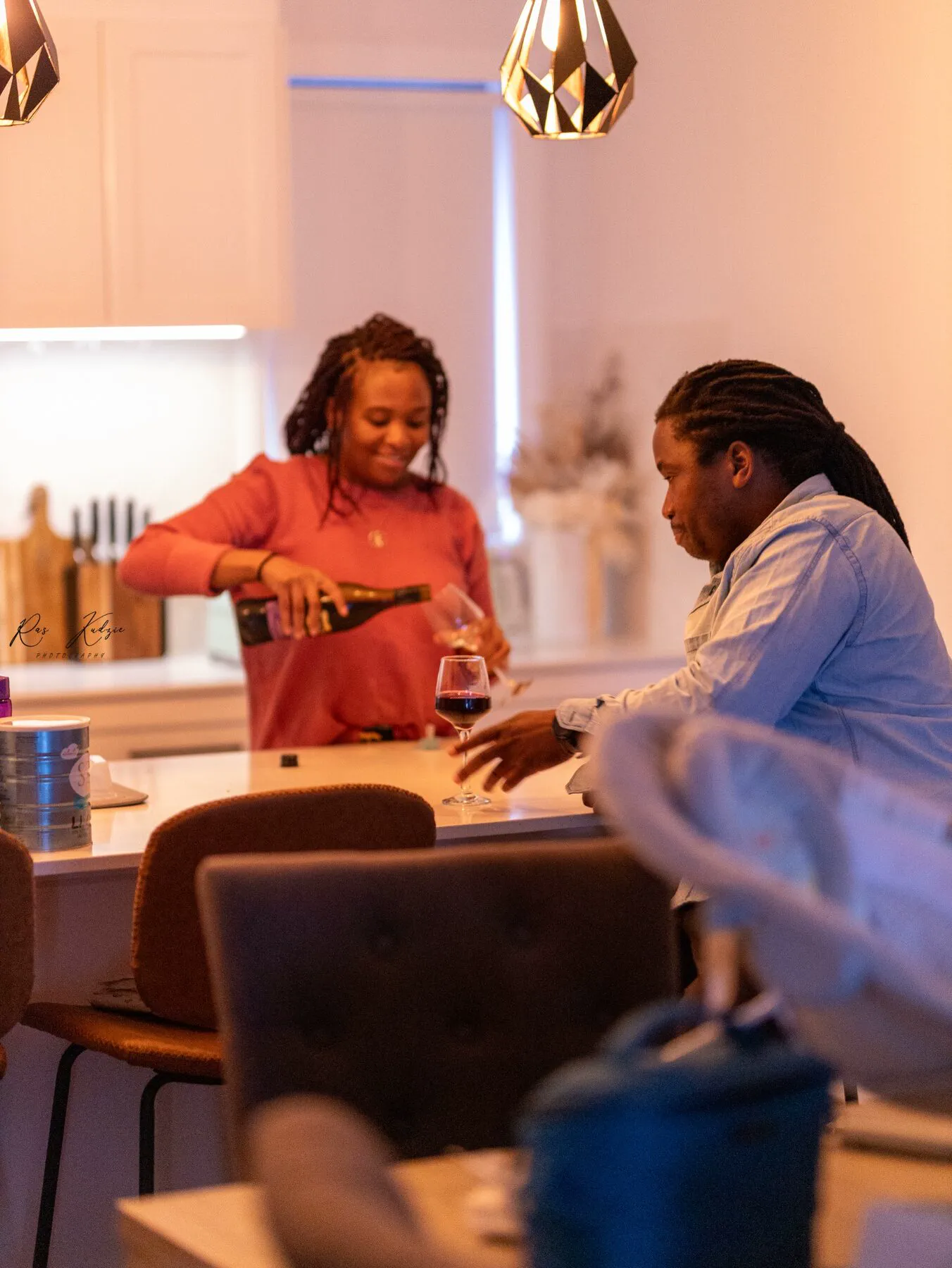 A couple sharing a quiet glass of wine at home
