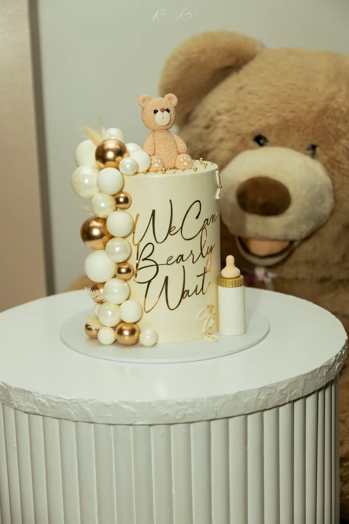 Teddy-bear themed celebration cake with gold and cream details