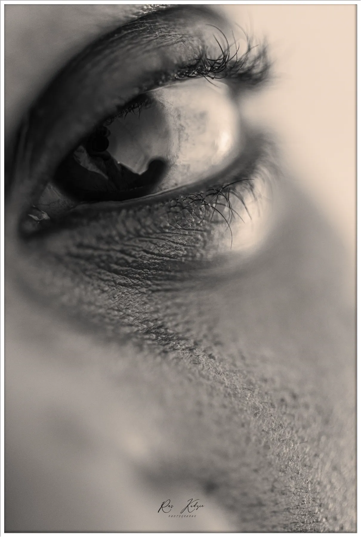 Black and white abstract close-up of a human eye and eyelashes
