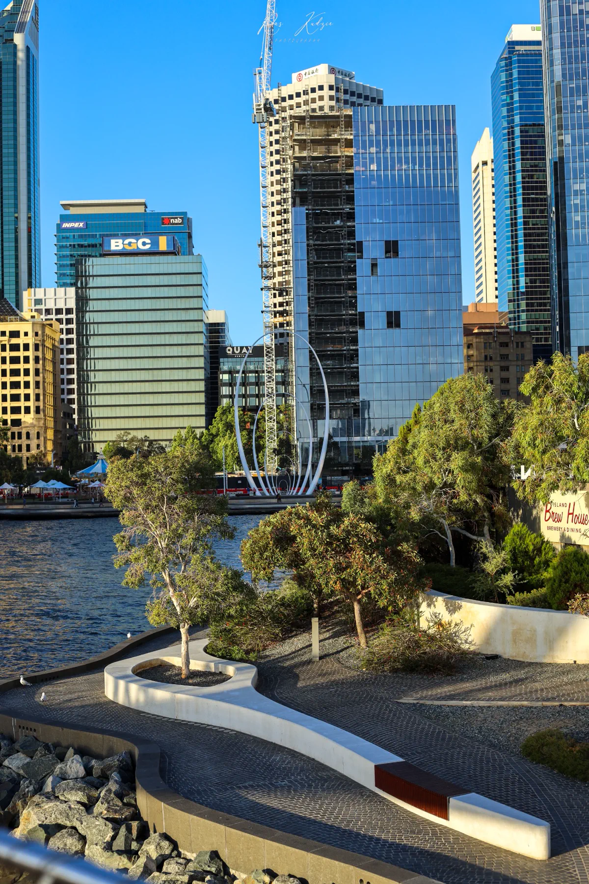 Perth skyline and Elizabeth Quay waterfront gardens in afternoon light