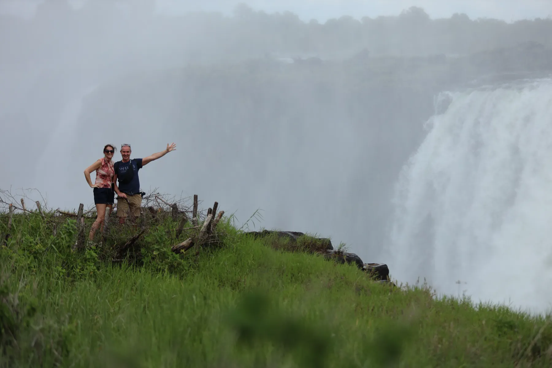 A couple smiling together beside Victoria Falls