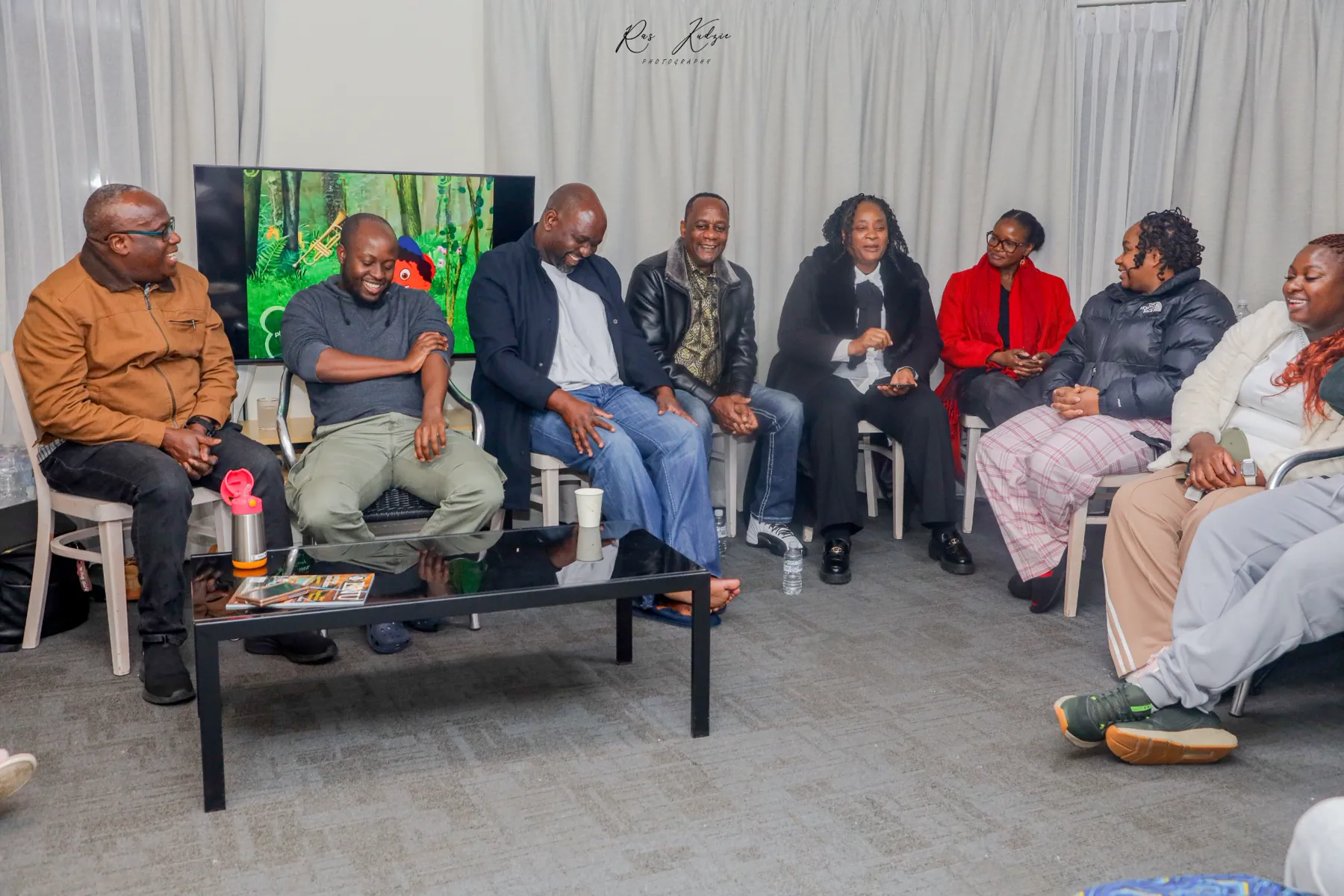 Friends and family sharing laughter during an indoor gathering