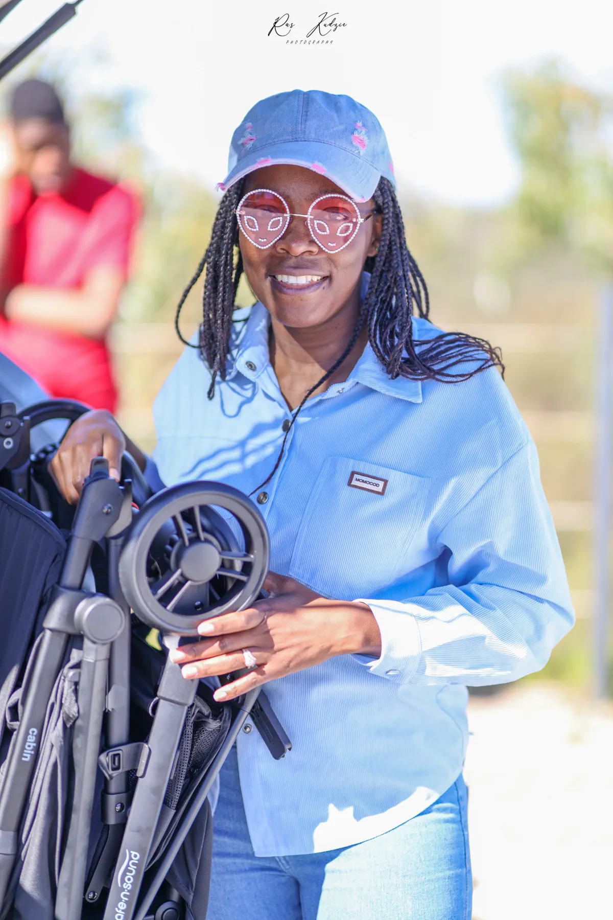 A woman smiling in playful alien-shaped glasses